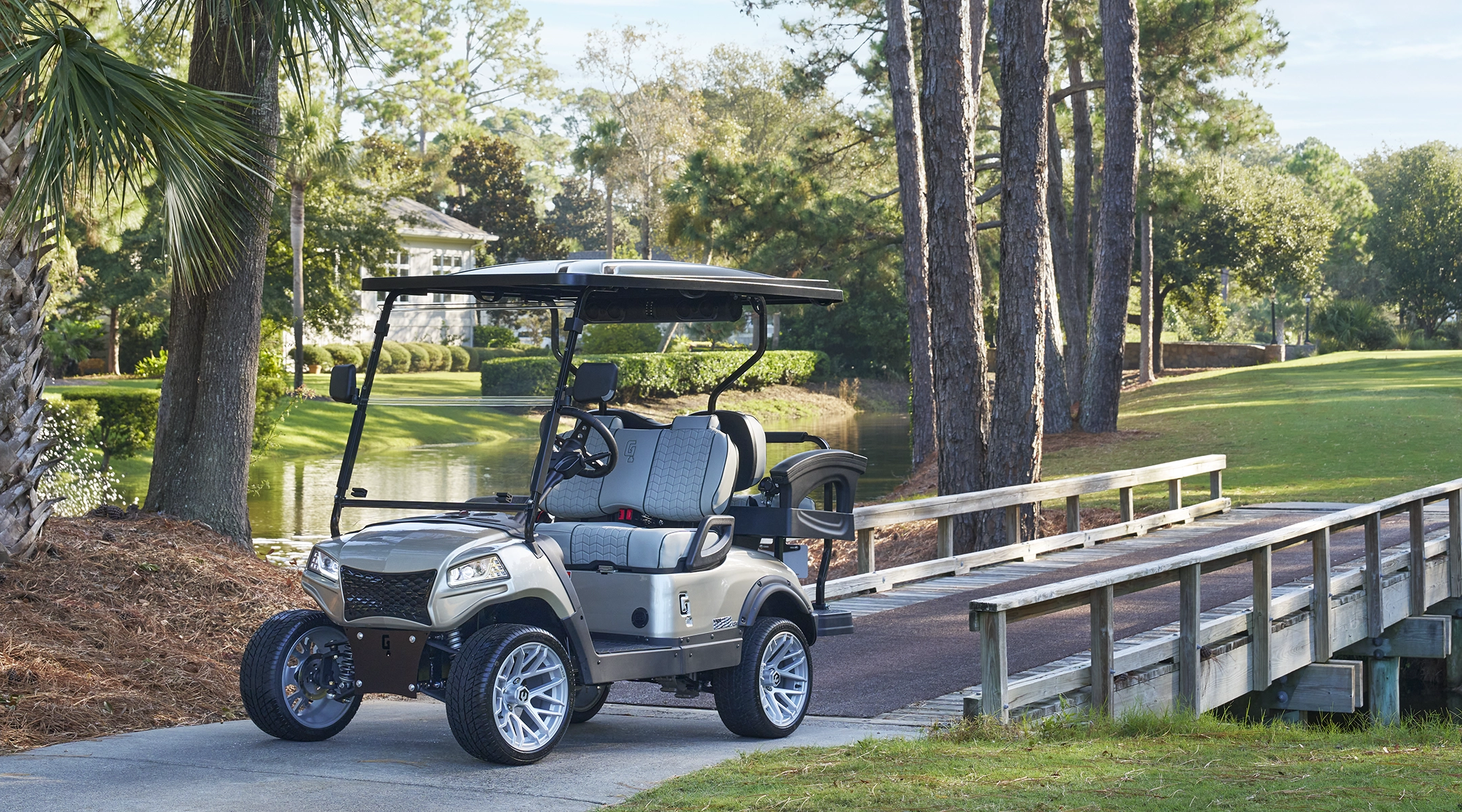 Honor Golf Cart on a golf course in front of a bridge.